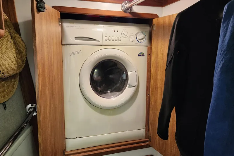 Slide: The Image of Washing machine inside 2003 Endeavour 44 TrawlerCat, wooden cabinet, nautical setting. - 67