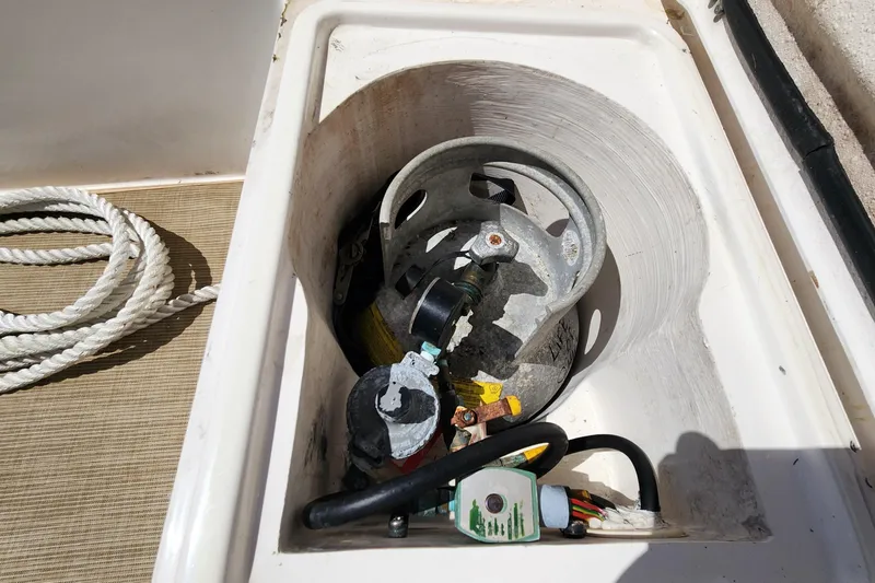Slide: The Image of Storage compartment on 2003 Endeavour 44 TrawlerCat with propane tank and coiled rope. - 69