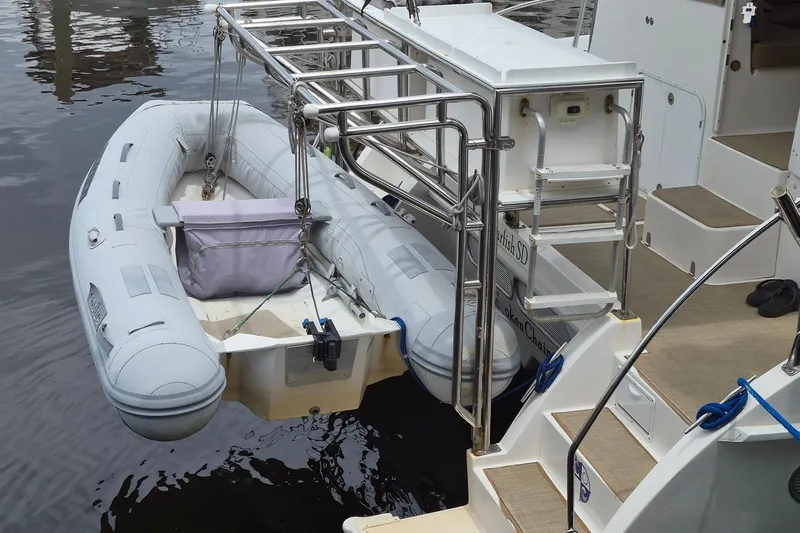 Slide: The Image of Inflatable dinghy secured on 2003 Endeavour 44 TrawlerCat yacht, docked by water. - 70