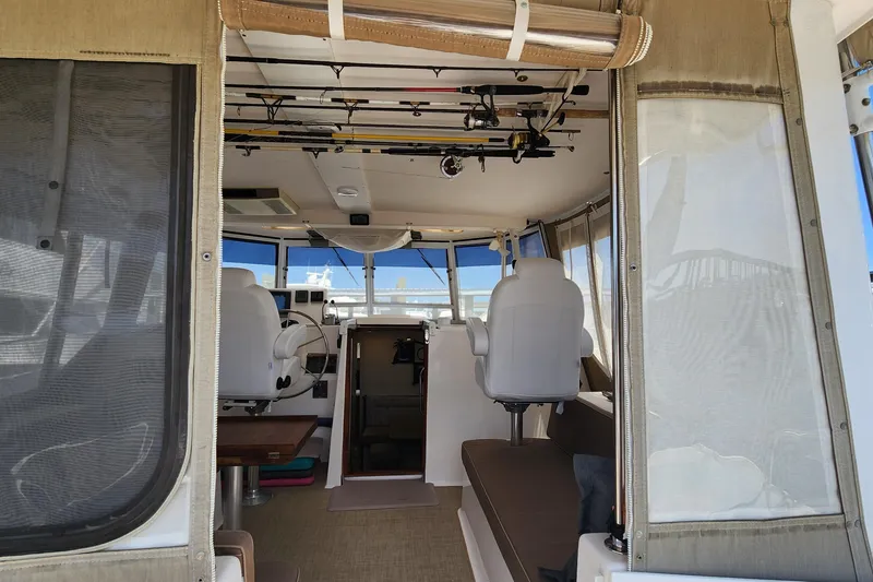 Slide: The Image of Interior view of 2003 Endeavour 44 TrawlerCat, featuring helm and seating area. - 8