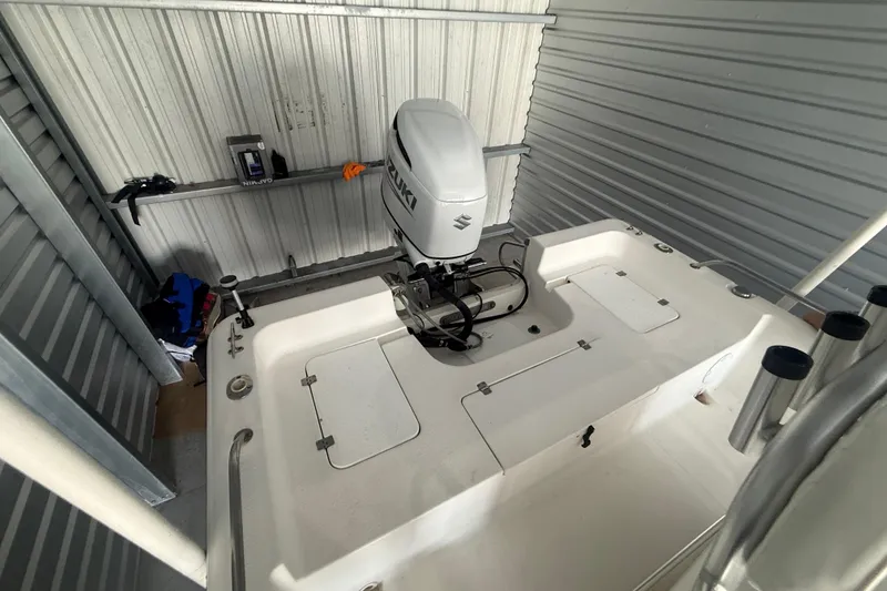 Slide: The Image of 2005 Sea Pro SV2400CC Bay Boat with Suzuki outboard motor in storage unit. - 11