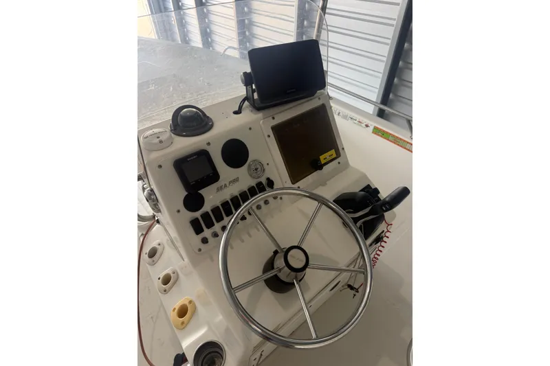 Slide: The Image of 2005 Sea Pro SV2400CC Bay Boat helm with steering wheel and navigation equipment. - 3