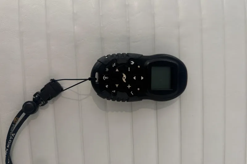 Slide: The Image of Black remote control on a white surface, likely for a 2005 Sea Pro SV2400CC Bay Boat. - 4