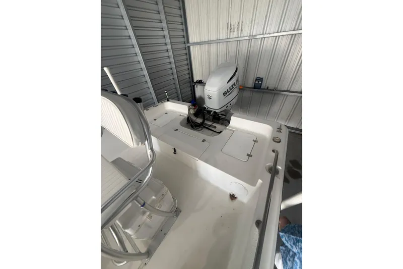 Slide: The Image of 2005 Sea Pro SV2400CC Bay Boat with Suzuki outboard motor in storage. - 7
