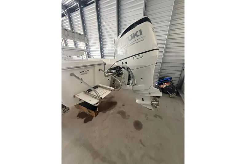 Slide: The Image of 2005 Sea Pro SV2400CC Bay Boat with Suzuki outboard motor in storage. - 8