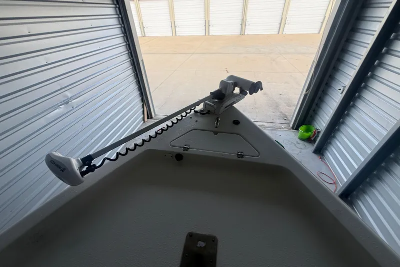 Slide: The Image of 2005 Sea Pro SV2400CC Bay Boat in storage with trolling motor attached. - 9