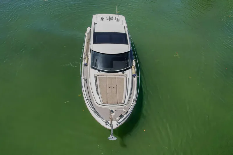 Slide: The Image of Aerial view of 2020 Jeanneau NC 37 boat on green water. - 11