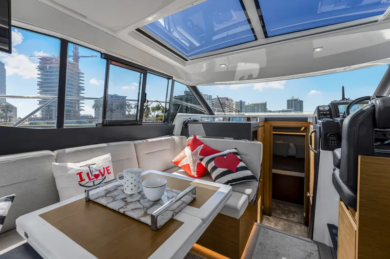Slide: The Image of Interior of 2020 Jeanneau NC 37 yacht with cozy seating and cityscape view. - 20
