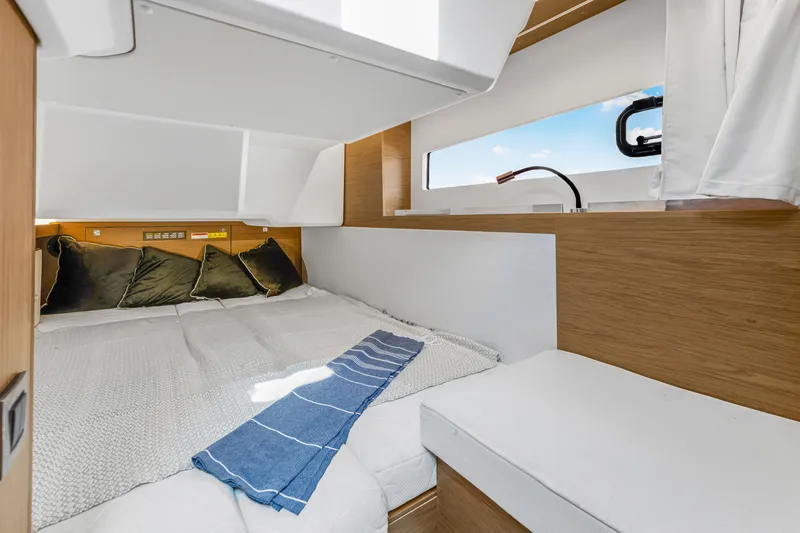 Slide: The Image of Cozy cabin interior of 2020 Jeanneau NC 37 yacht with modern bedding and natural light. - 31