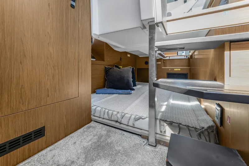 Slide: The Image of Interior cabin of 2020 Jeanneau NC 37 yacht with cozy bedding and wooden finish. - 33
