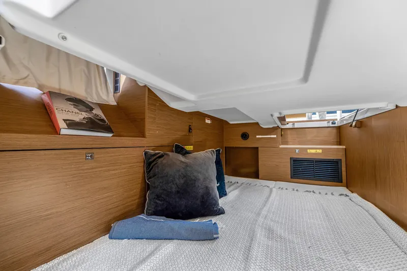Slide: The Image of Cozy cabin interior of 2020 Jeanneau NC 37 yacht with pillows and book. - 34