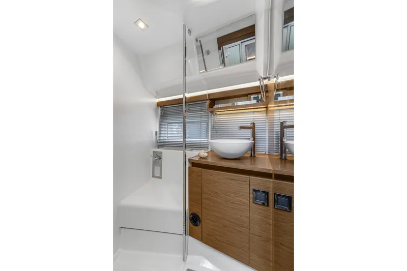 Slide: The Image of Modern bathroom interior of 2020 Jeanneau NC 37 yacht with sleek design and wooden cabinetry. - 36