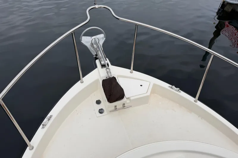 Slide: The Image of Bow of 2014 Ranger Tugs R-25 SC boat with anchor, on calm water. - 12