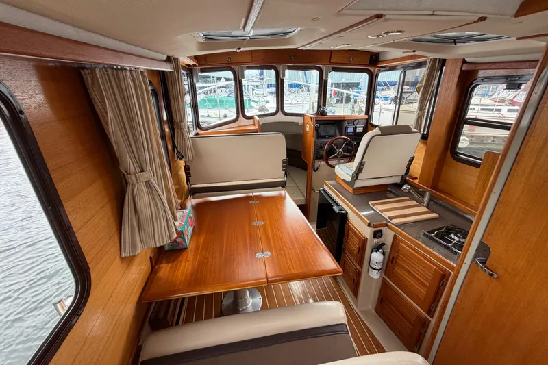 Slide: The Image of Interior of 2014 Ranger Tugs R-25 SC boat with wood finish and compact kitchen. - 22