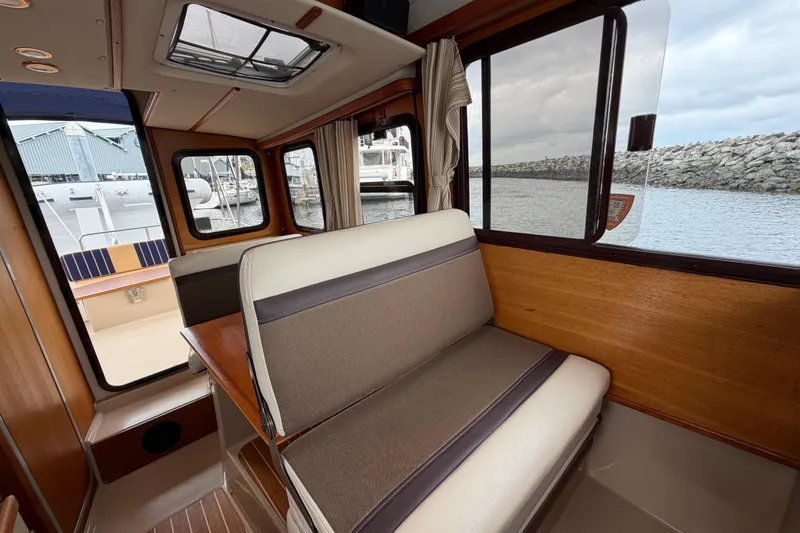Slide: The Image of Interior of 2014 Ranger Tugs R-25 SC boat with seating and window view. - 24