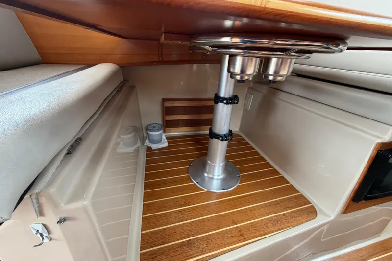 Slide: The Image of Interior of 2014 Ranger Tugs R-25 SC boat with wood accents and seating area. - 27