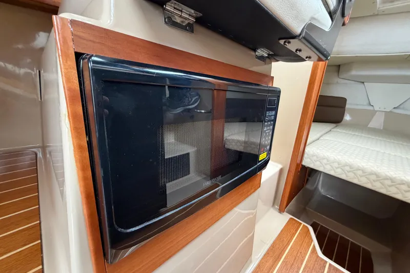 Slide: The Image of Microwave in 2014 Ranger Tugs R-25 SC cabin interior with wood accents. - 28