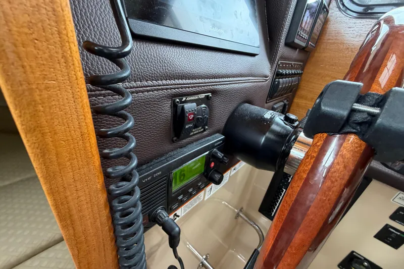 Slide: The Image of 2014 Ranger Tugs R-25 SC helm with VHF radio and wooden steering wheel. - 31