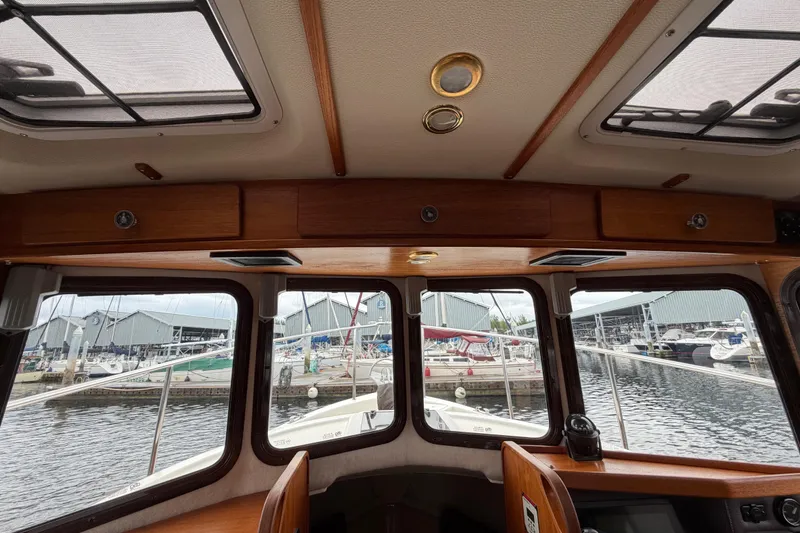 Slide: The Image of Interior view of 2014 Ranger Tugs R-25 SC boat with marina backdrop. - 34