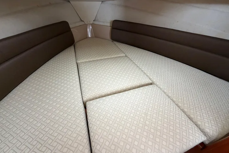 Slide: The Image of 2014 Ranger Tugs R-25 SC cabin interior with patterned cushions and brown side bolsters. - 37