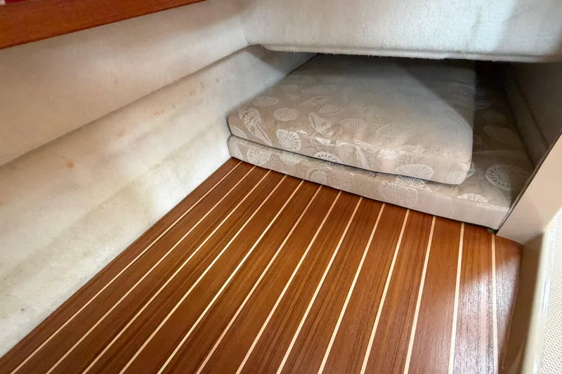 Slide: The Image of 2014 Ranger Tugs R-25 SC cabin interior with wooden flooring and cushioned seating. - 38