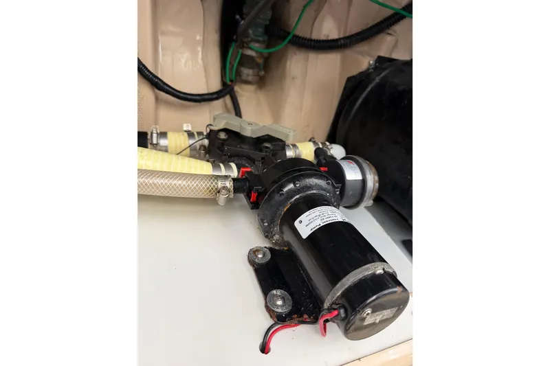 Slide: The Image of Engine compartment of a 2014 Ranger Tugs R-25 SC, featuring hoses and mechanical components. - 46