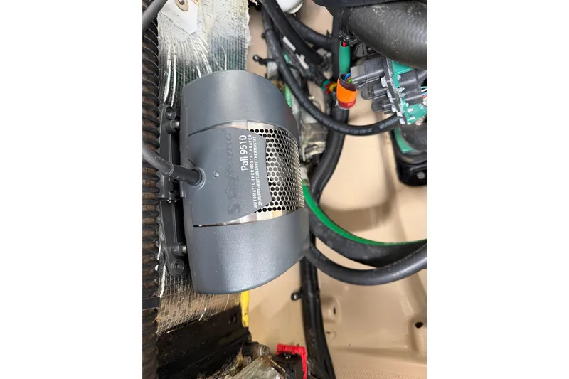Slide: The Image of Engine compartment of a 2014 Ranger Tugs R-25 SC, featuring a Pali 9510 heater. - 47