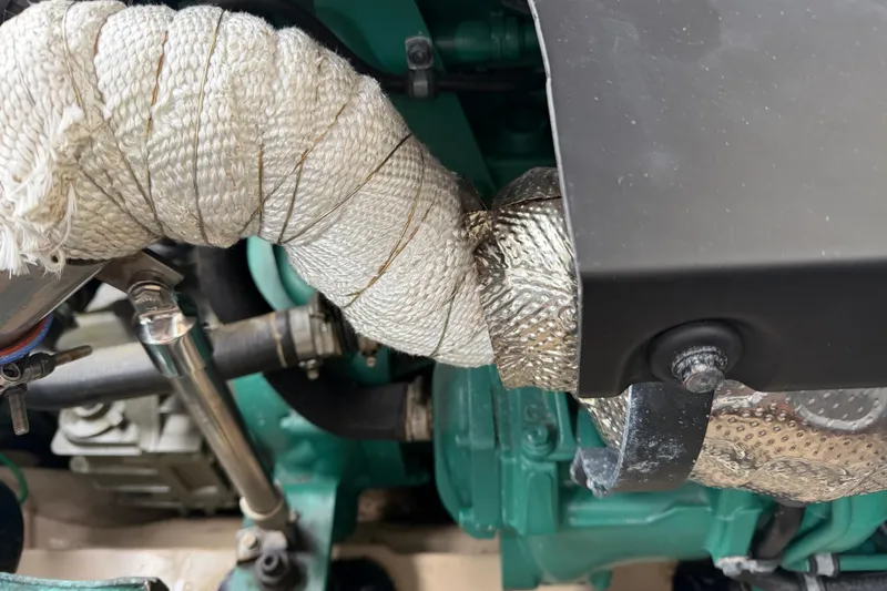 Slide: The Image of Engine compartment of 2014 Ranger Tugs R-25 SC, showing wrapped exhaust components. - 48