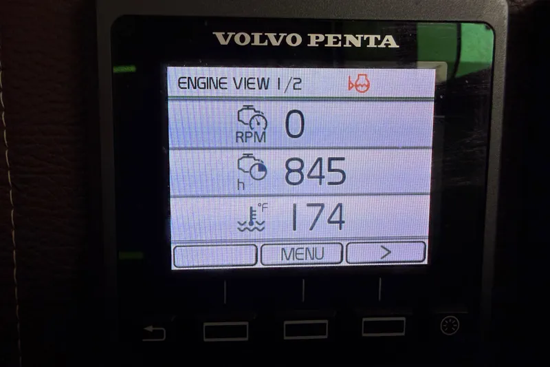 Slide: The Image of Volvo Penta engine display showing RPM, hours, and temperature on a 2014 Ranger Tugs R-25 SC. - 49