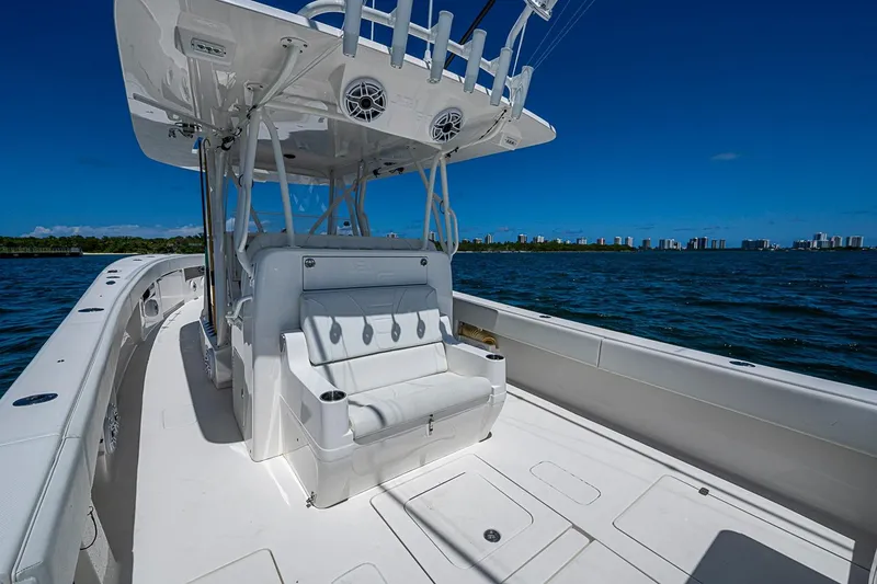 Slide: The Image of 2023 SeaVee 390B boat interior with seating, ocean view, and city skyline. - 10