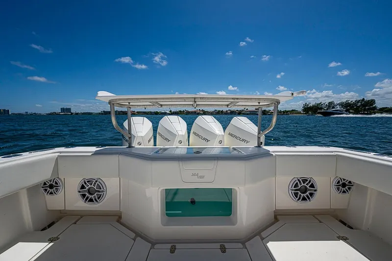 Slide: The Image of 2023 SeaVee 390B boat with Mercury engines on open water under clear blue sky. - 12