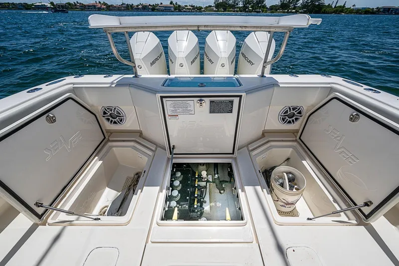 Slide: The Image of 2023 SeaVee 390B boat deck with storage compartments and Mercury engines. - 17