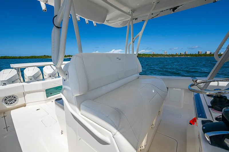 Slide: The Image of 2023 SeaVee 390B boat interior with white seating and multiple outboard engines. - 21