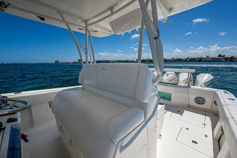 Slide: The Image of 2023 SeaVee 390B boat interior with white seating, ocean view, and clear blue sky. - 25