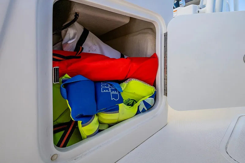 Slide: The Image of Storage compartment on 2023 SeaVee 390B boat with life jackets and gear. - 26