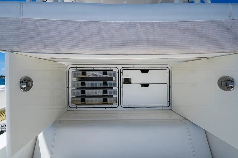 Slide: The Image of 2023 SeaVee 390B boat storage compartments with organized tackle boxes and drawers. - 27