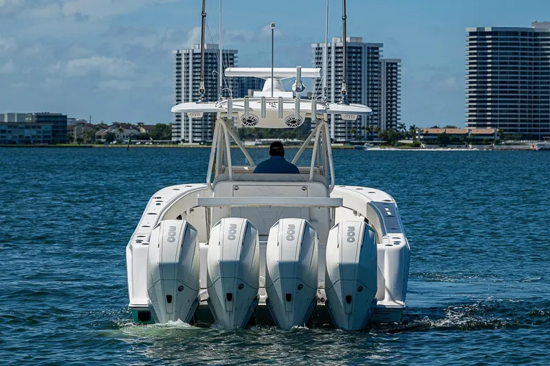 Slide: The Image of 2023 SeaVee 390B boat with four engines cruising near city skyline. - 30