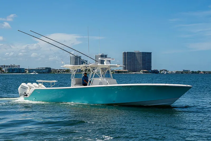 Slide: The Image of 2023 SeaVee 390B boat cruising on water with city skyline in background. - 31
