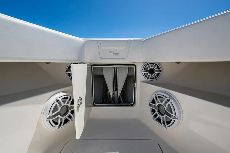 Slide: The Image of 2023 SeaVee 390B boat anchor compartment with speakers under clear blue sky. - 4