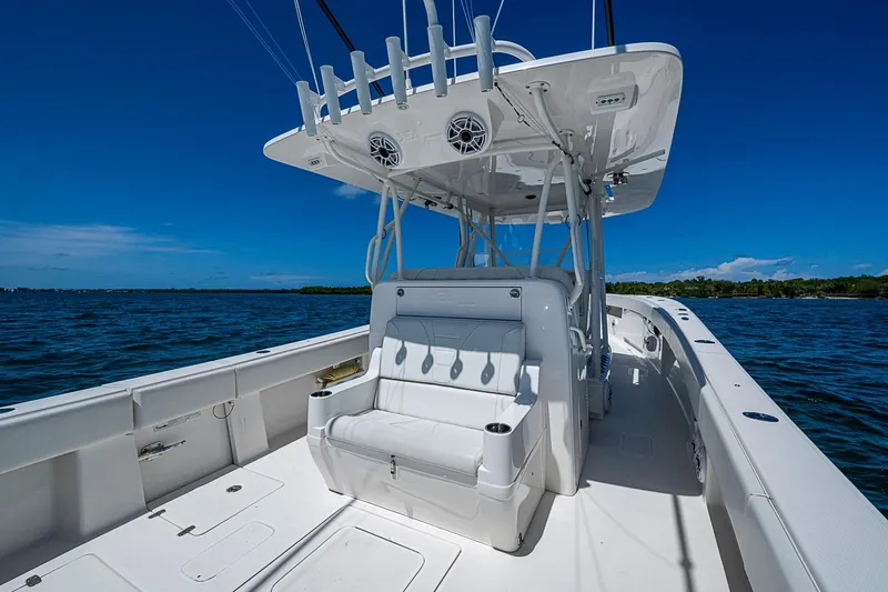 Slide: The Image of 2023 SeaVee 390B boat on open water, featuring sleek white seating and fishing rod holders. - 8