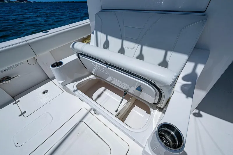 Slide: The Image of 2023 SeaVee 390B boat interior with open storage compartment and cup holders. - 9