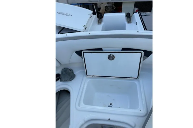 Slide: The Image of 2020 Four Winns HD220 boat interior with open storage compartment. - 5