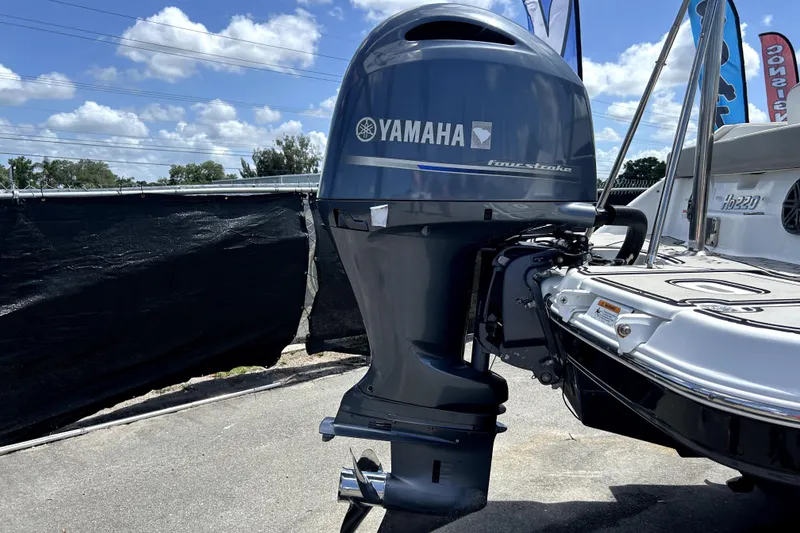 Slide: The Image of 2020 Four Winns HD220 boat with Yamaha four-stroke outboard motor, parked outdoors. - 3