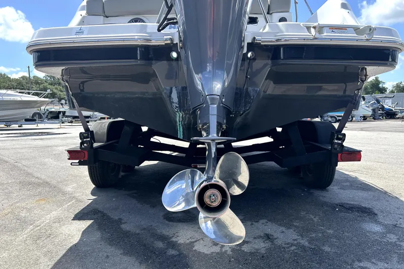 Slide: The Image of 2020 Four Winns HD220 boat on trailer, rear view with propeller visible. - 5