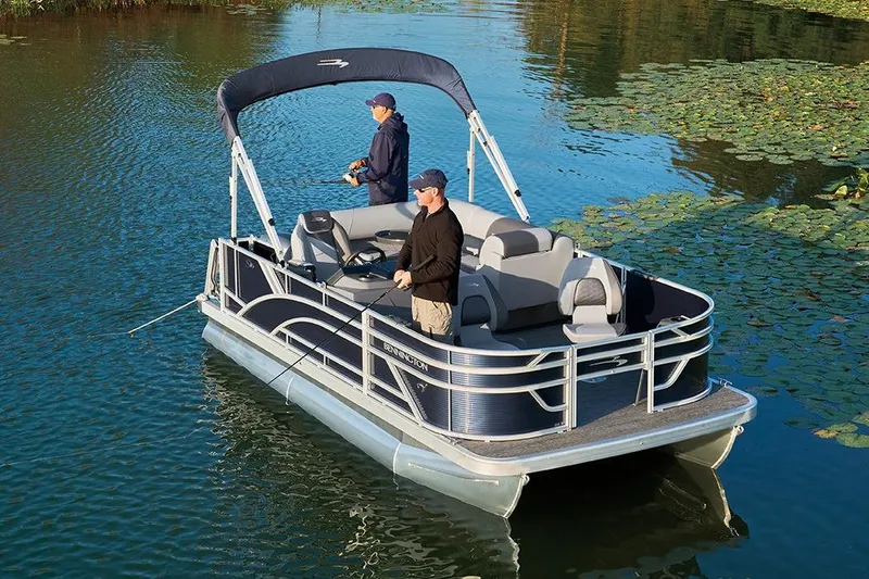 The Image of 2026 Bennington 23 S-One Swingback pontoon boat on a serene lake. - 6