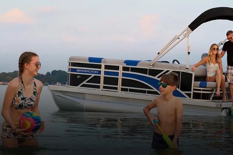 Slide: The Image of Family enjoying water beside Bennington 23 S-One Swingback 2026. - 7