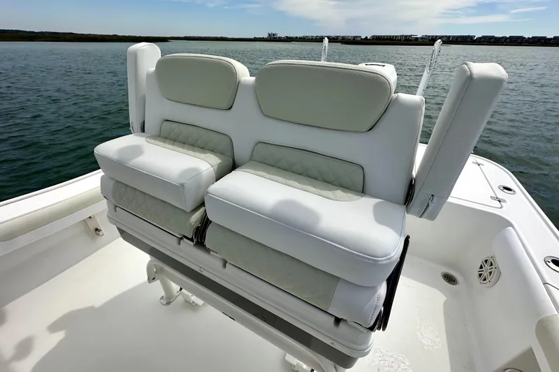 Slide: The Image of Luxurious seating on a 2020 Caymas 26 HB boat, featuring plush white cushions. - 10
