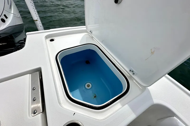 Slide: The Image of Open storage compartment on 2020 Caymas 26 HB boat, near water. - 11