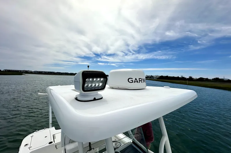 Slide: The Image of 2020 Caymas 26 HB boat with Garmin radar on calm water under cloudy sky. - 14