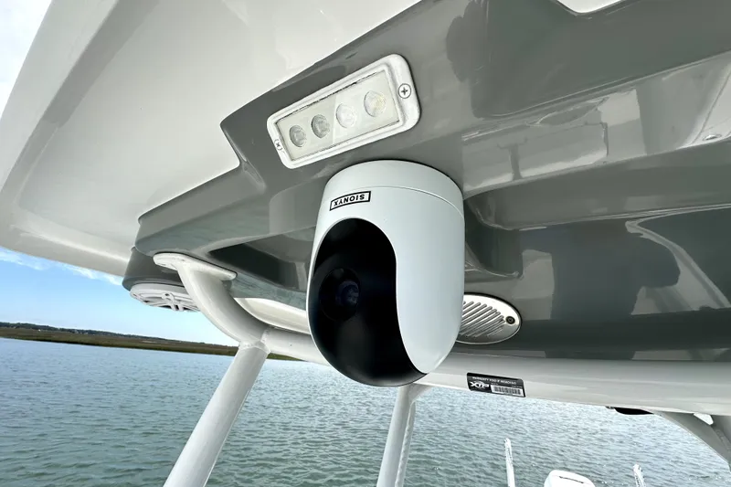 Slide: The Image of 2020 Caymas 26 HB boat with mounted security camera and LED lights on the canopy. - 18
